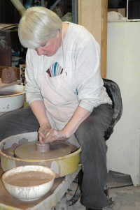 A photo of Debra Ocepek making clay chalice at the potter's wheel, Cuyahoga Falls Ohio, potter at wheel as in Jeremiah 18